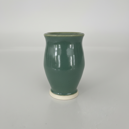 Side angle view of green ceramic vase